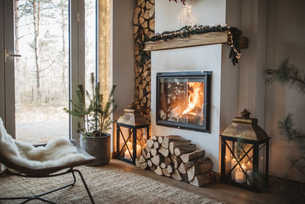 A-rustic-living-room-decorated-with-a-log-cabin-approach-and-a-fireplace-with-carpet-1024x683